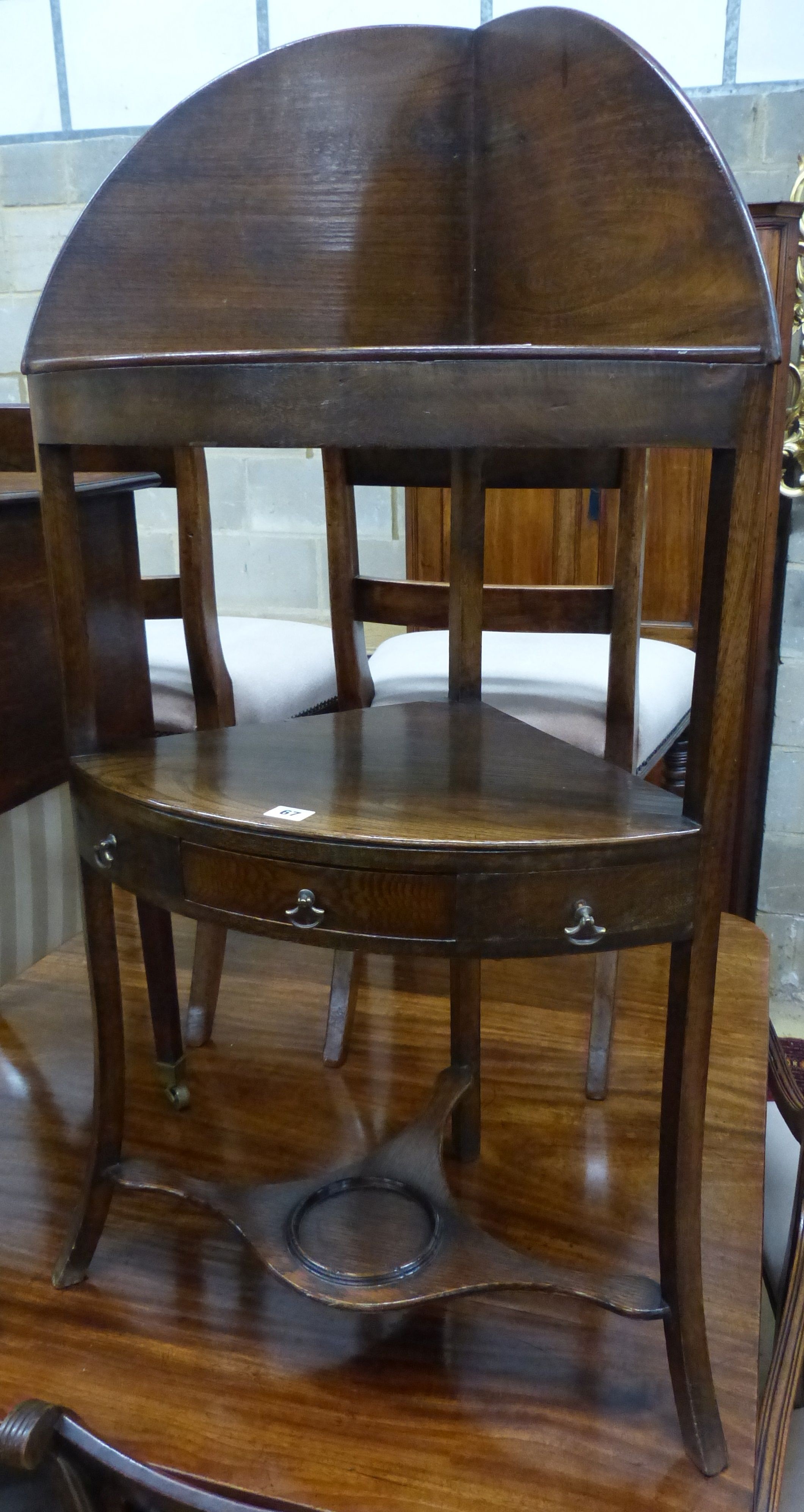 A George III oak and elm three tier corner washstand, W.56cm D.39cm H.110cm